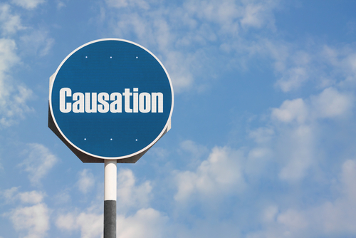 A road sign labeled causation against a blue sky, symbolizing legal concepts involved in brain injury causation.