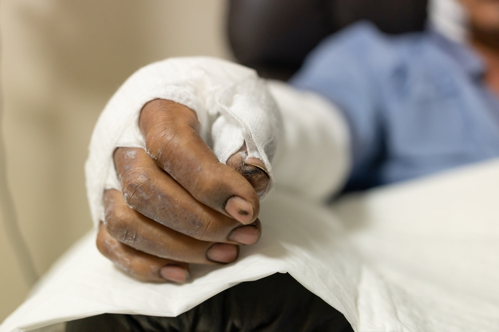 Patient with a bandaged hand in a hospital